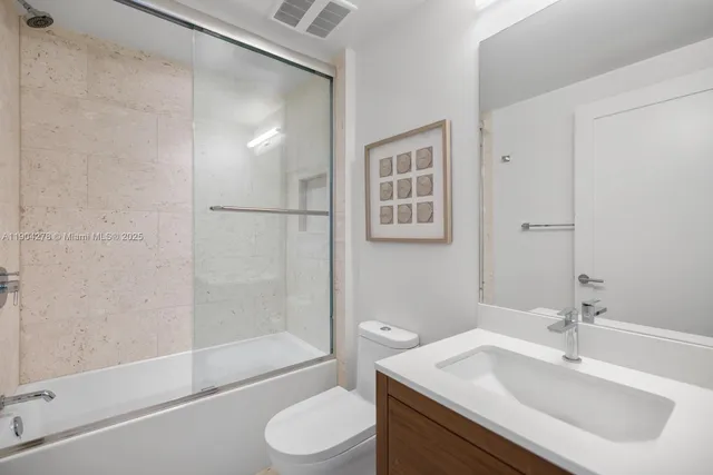 a bathroom with a sink toilet and shower