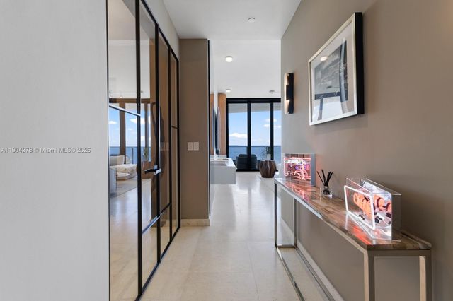 a hallway with a couch and a stove next to a window