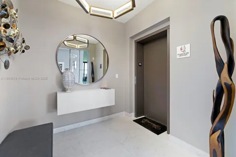 a view of staircase with two mirror