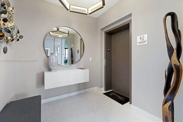 a view of staircase with two mirror