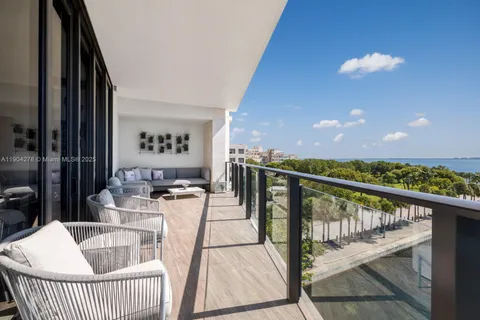a view of a balcony dining table chairs and wooden floor