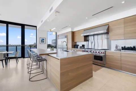 a kitchen with stainless steel appliances kitchen island granite countertop a stove and cabinets