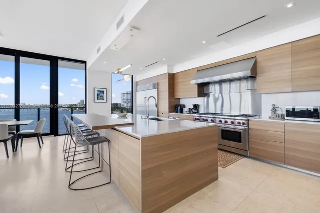 a kitchen with stainless steel appliances kitchen island granite countertop a stove and cabinets