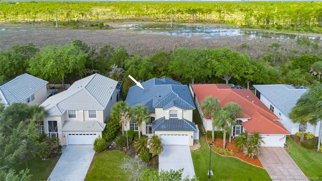 7213 Southeast Magellan Lane Stuart, FL 34997 - Photo 1 of 47 an aerial view of house with yard and lake view