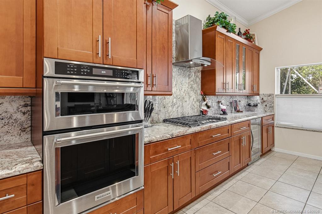 7213 Southeast Magellan Lane Stuart, FL 34997 - Photo 12 of 47 a kitchen with granite countertop a stove microwave and sink