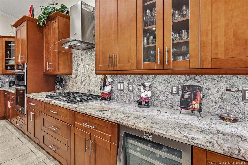 7213 Southeast Magellan Lane Stuart, FL 34997 - Photo 14 of 47 a kitchen with granite countertop a sink stainless steel appliances and cabinets