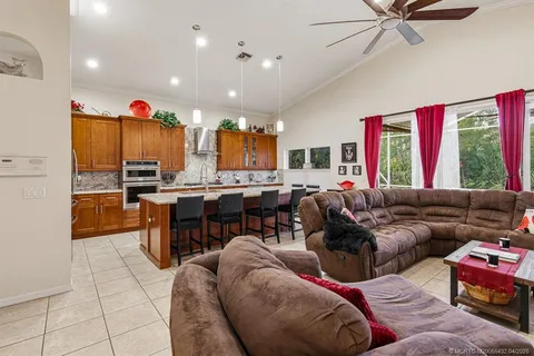 a living room with furniture kitchen and a window