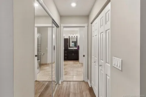 a view of a hallway with wooden floor and staircase