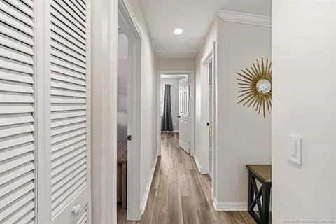 a view of a hallway with a door and a window