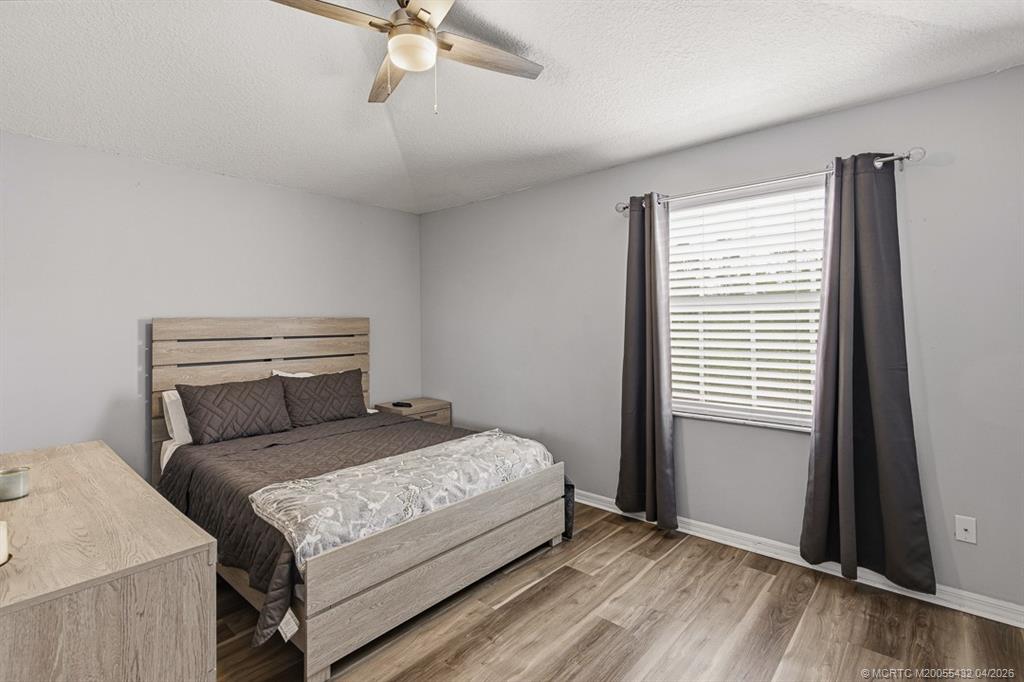 7213 Southeast Magellan Lane Stuart, FL 34997 - Photo 30 of 47 a bedroom with a bed and a window