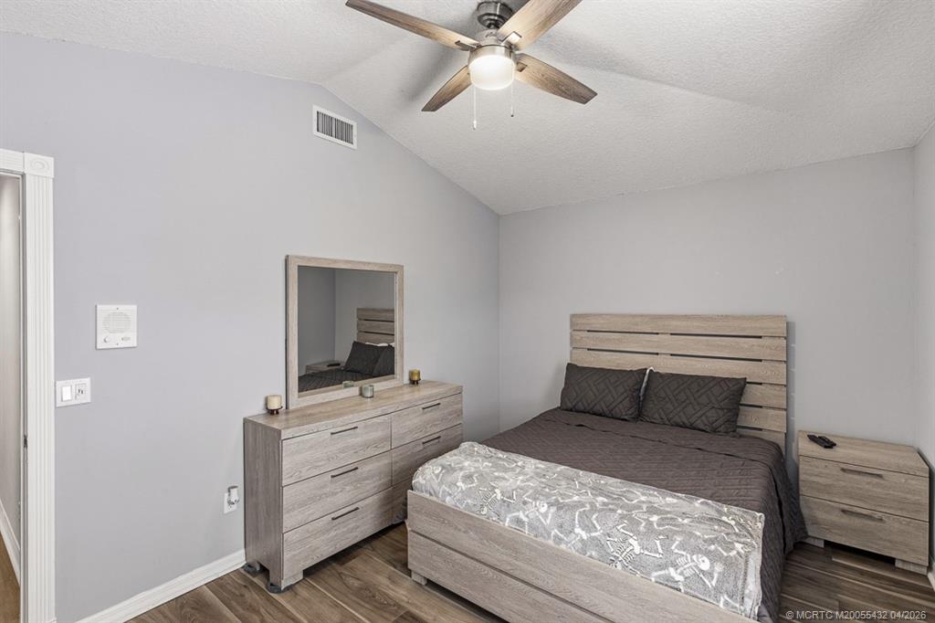 7213 Southeast Magellan Lane Stuart, FL 34997 - Photo 32 of 47 a bedroom with a bed and a dresser