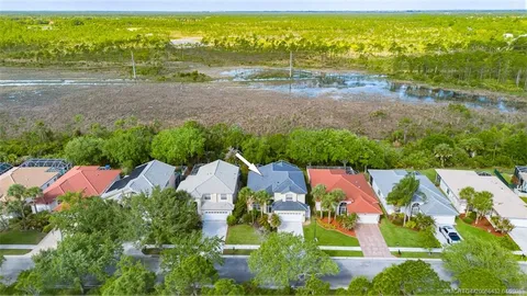 an aerial view of residential houses with outdoor space and swimming pool