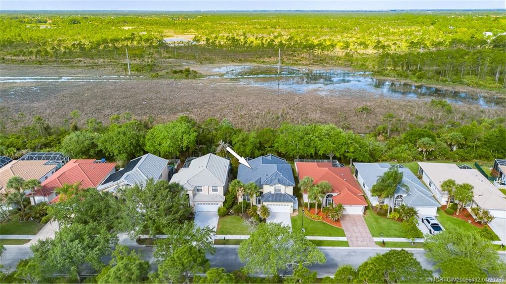 7213 Southeast Magellan Lane Stuart, FL 34997 - Photo 37 of 47 an aerial view of residential houses with outdoor space and swimming pool