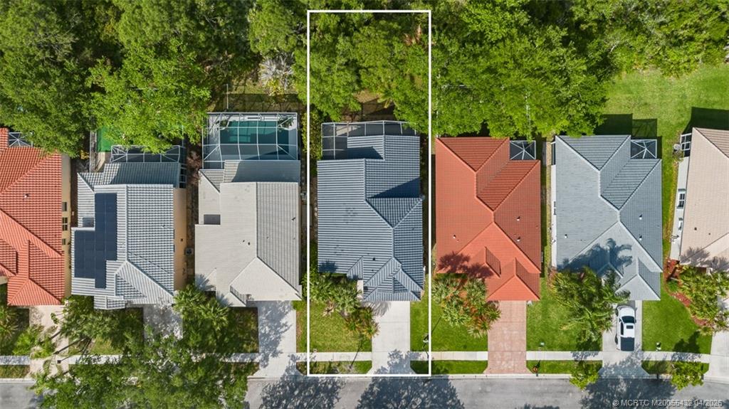 7213 Southeast Magellan Lane Stuart, FL 34997 - Photo 39 of 47 an aerial view of a house with a yard and large trees