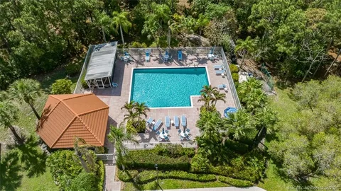 an aerial view of a house with a yard basket ball court and outdoor seating