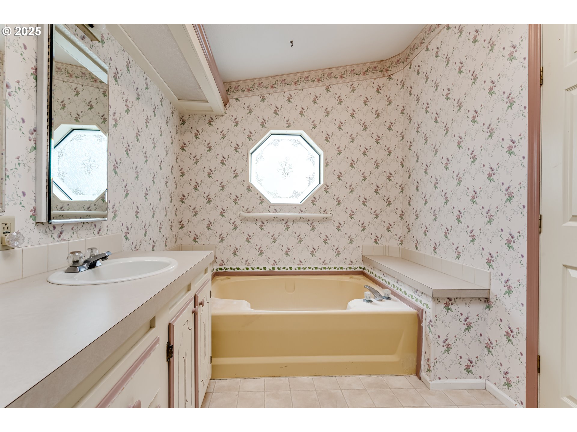 1475 Green Acres Road, Unit 83 Eugene, OR 97408 - Photo 19 of 19 a bathroom with a bathtub sink mirror and vanity