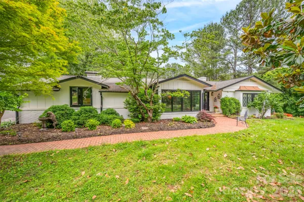 a front view of a house with yard and porch