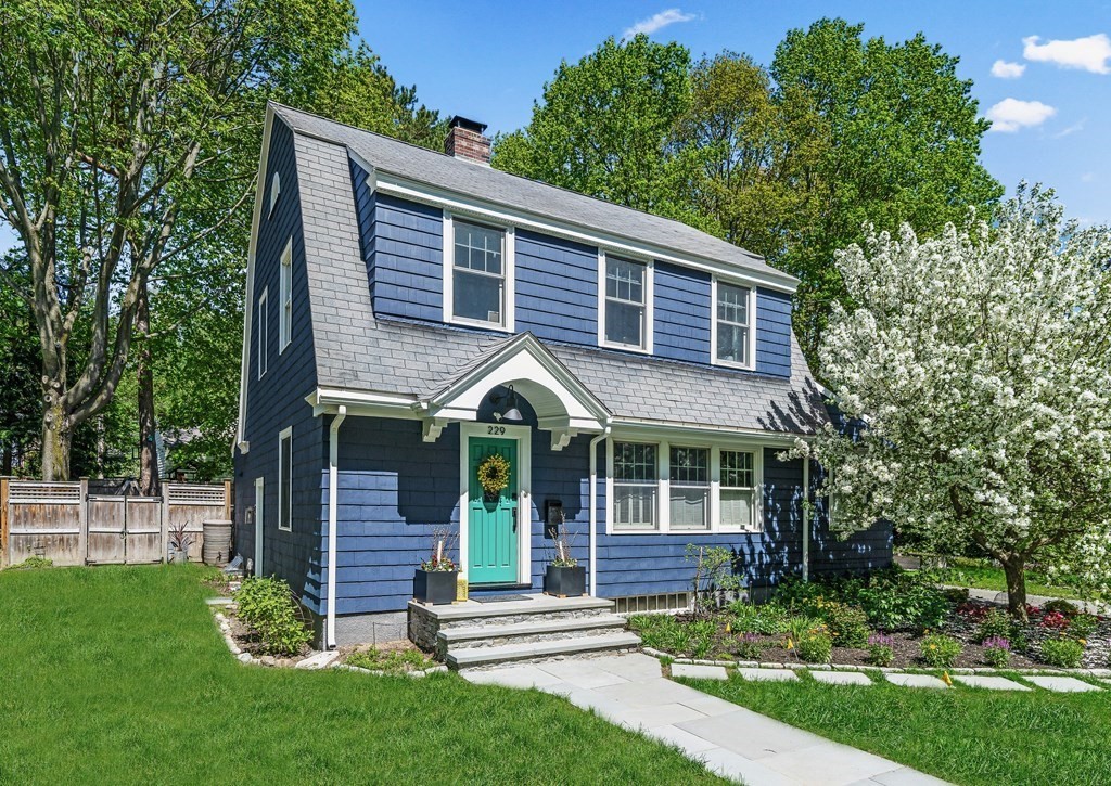 a front view of a house with a garden