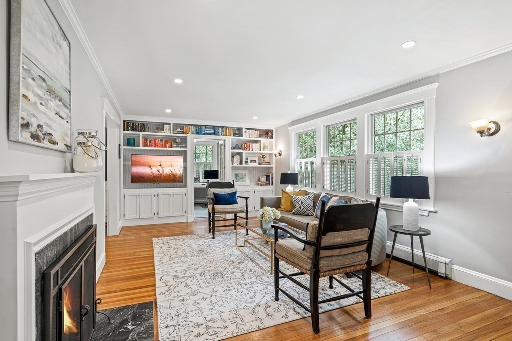 229 Weston Road Wellesley, MA 02482 - Photo 2 of 24 a living room with furniture a flat screen tv and a fireplace
