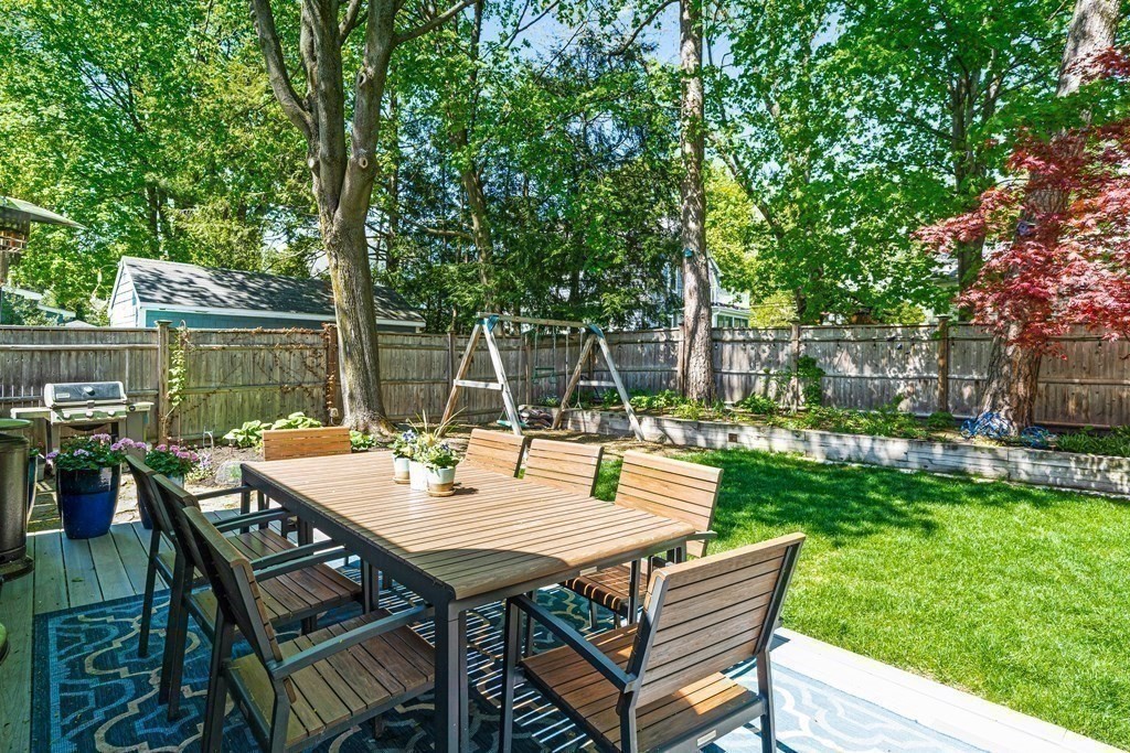 229 Weston Road Wellesley, MA 02482 - Photo 23 of 24 a view of a backyard with a table and chairs