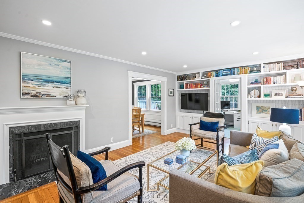 229 Weston Road Wellesley, MA 02482 - Photo 4 of 24 a living room with furniture a flat screen tv and a fireplace