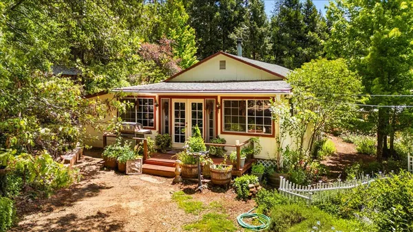 a front view of a house with a garden