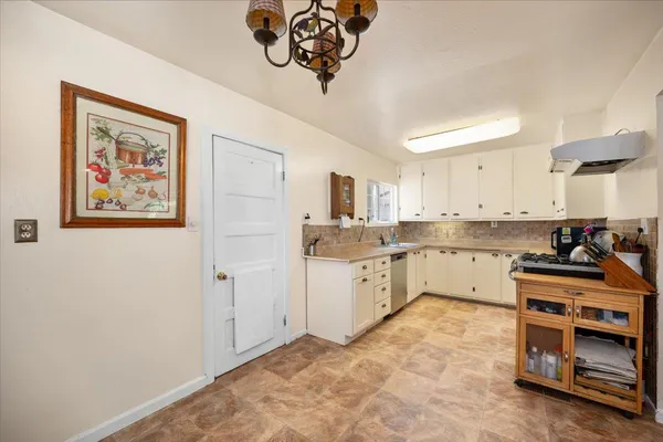 a kitchen with stainless steel appliances a stove a sink and a refrigerator