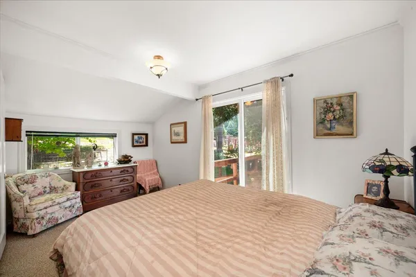 a bed room with a bed and a painting on the wall