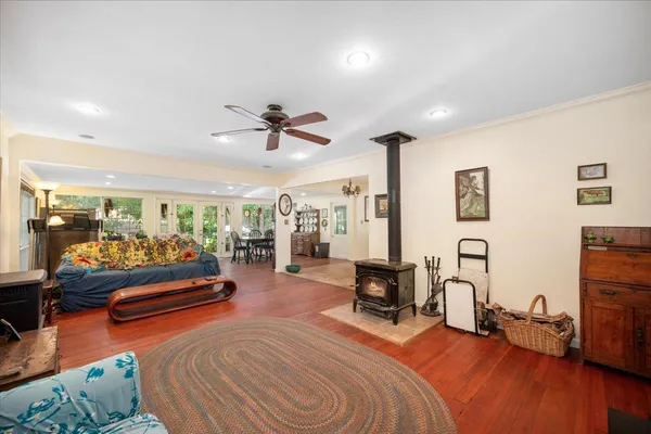 a bedroom with furniture and a large window