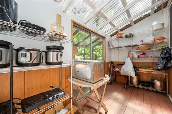 a bedroom with a bed mirror and window