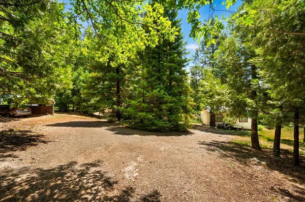 a backyard of a house with lots of green space and garden