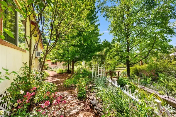 a view of a house with sitting area and garden