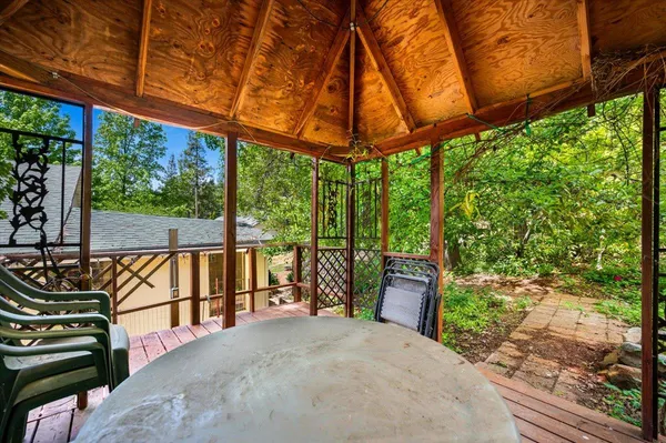 an aerial view of a house with a yard and covered with swimming pool