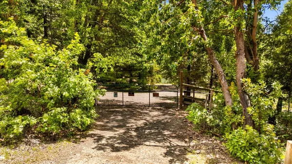 an aerial view of house with yard and mountain view in back