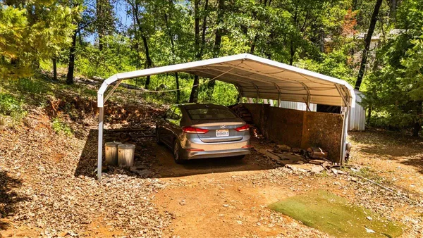 a view of a house with pool and tree s