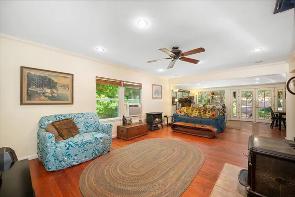 a living room with furniture gym equipment and a large window