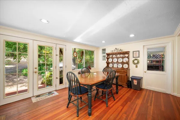 a view of a dining room with furniture window and wooden floor