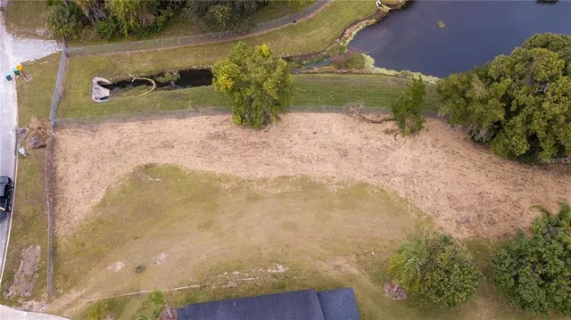 a backyard of a house with a yard and outdoor seating