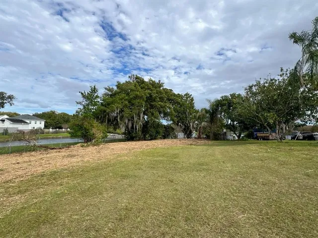 a view of a field with an trees in front of it