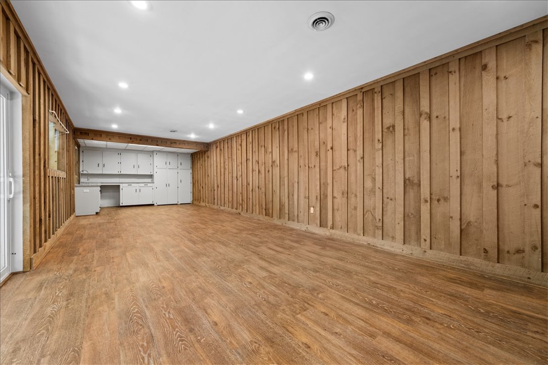 103 Satula Lane Clemson, SC 29631 - Photo 34 of 50 This spacious room features rustic wood paneling and sleek wood flooring, perfect for versatile living.