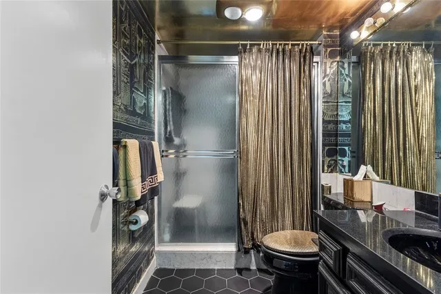 a bathroom with a sink toilet and shower