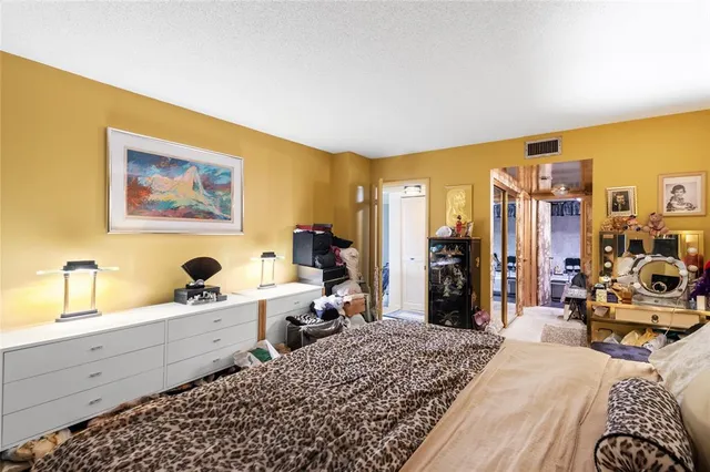 a bed room with a bed and a large window