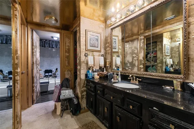 a bathroom with a sink double vanity and a large mirror