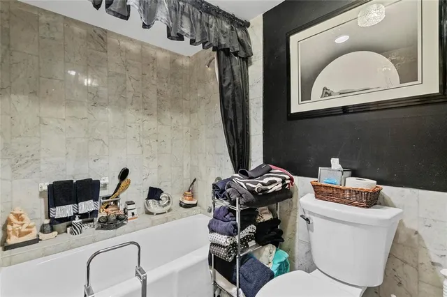 a bathroom with a toilet a sink and a mirror