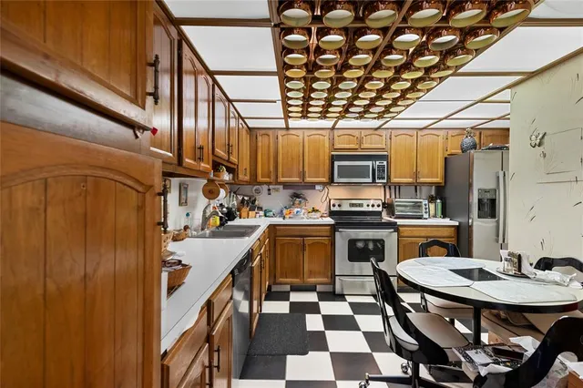 a kitchen with a sink a stove and chairs