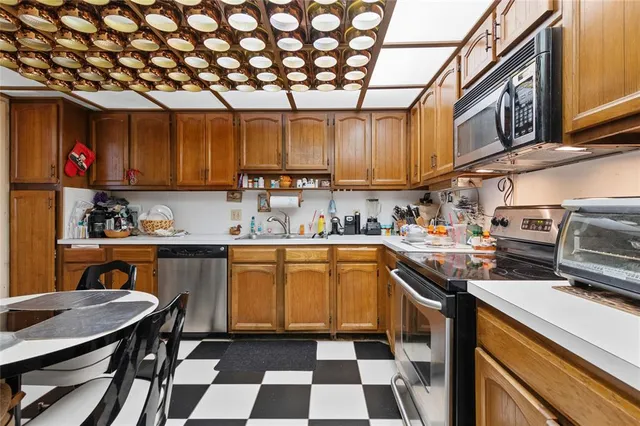 a kitchen with a sink a stove and cabinets