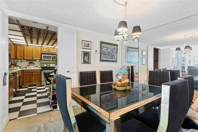 a kitchen with stainless steel appliances a stove a refrigerator and cabinets