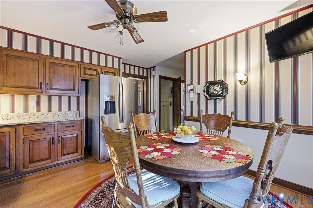 8216 Chainmaile Road North Chesterfield, VA 23235 - Photo 11 of 36 a view of a dining room with furniture window and wooden floor
