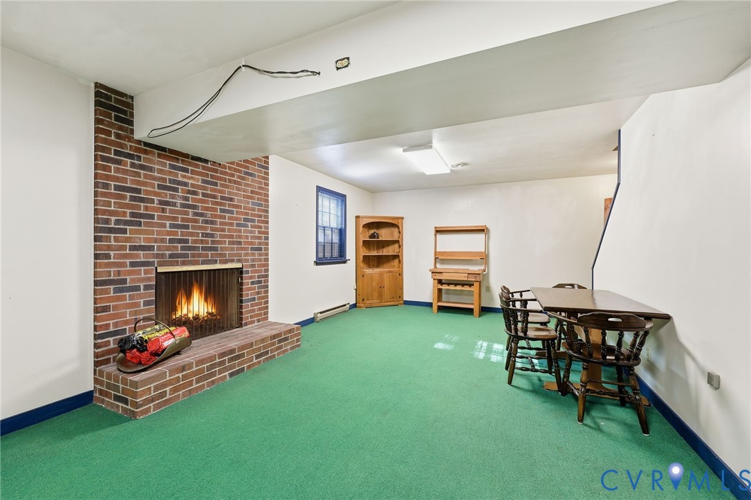 8216 Chainmaile Road North Chesterfield, VA 23235 - Photo 17 of 36 a living room with furniture and a fireplace