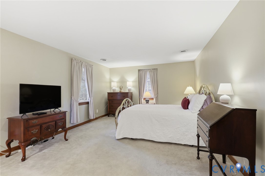 8216 Chainmaile Road North Chesterfield, VA 23235 - Photo 18 of 36 a bedroom with a bed and a flat screen tv